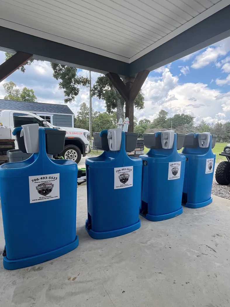 Blue dual-sided handwashing stations under a covered work area