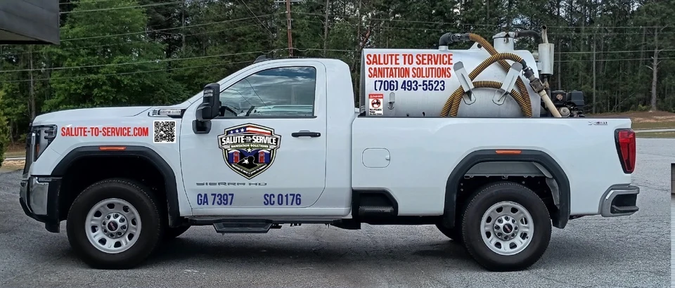 Salute To Service branded white pump service truck.