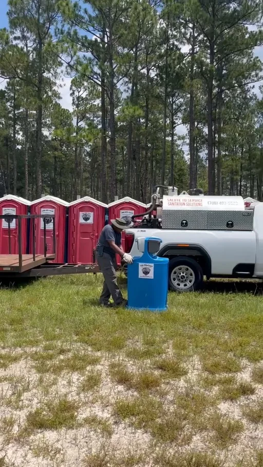 Authentic video still of an S2S crew member working beside handwashing equipment