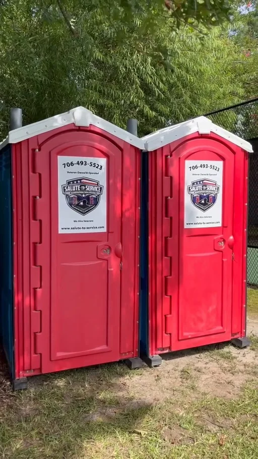 Authentic S2S portable restrooms beside a fence